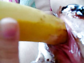 Black haired and hot legal age teenager is inserting banana in her vagina